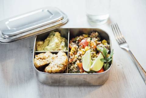 Bento box of quinoa salad with vegetables and lime, avocado cream and cauliflower dumplings  IPF00496