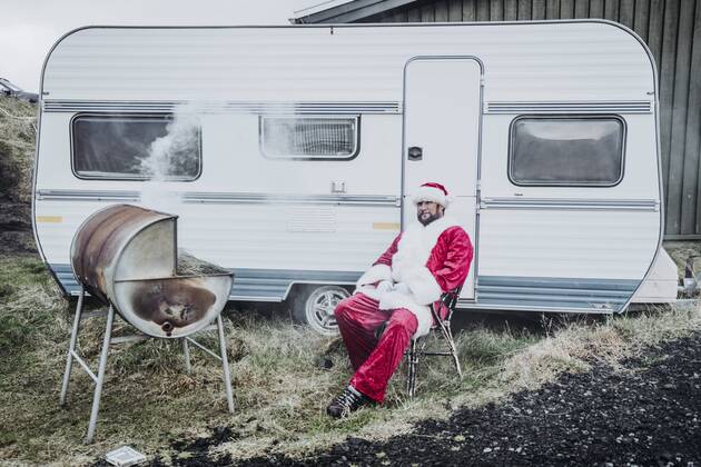 Iceland, Santa Claus sitting in front of caravan barbecueing model released Symbolfoto  OCMF00182