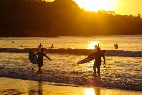 Surfers at sunset on the beach, Bali, Indonesia model released Symbolfoto  KNTF02665