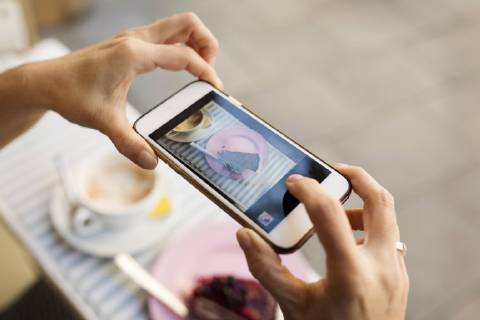 Female hands taking a picture of piece of cake with smartphone model released Symbolfoto  VABF02229