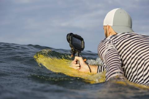 Indonesia, Bali, man with waterproof smartphone in the sea model released Symbolfoto  KNTF02641