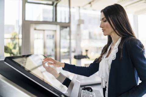 Businesswoman operating machine in a modern factory model released Symbolfoto property released  DIGF06609