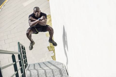 Man in black sportswear jumping in the air on staircase model released Symbolfoto  JSMF00942