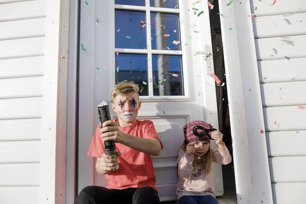 Brother and little sister made up for carnival sitting in front of entry door model released Symbolfoto property released  KMKF00787
