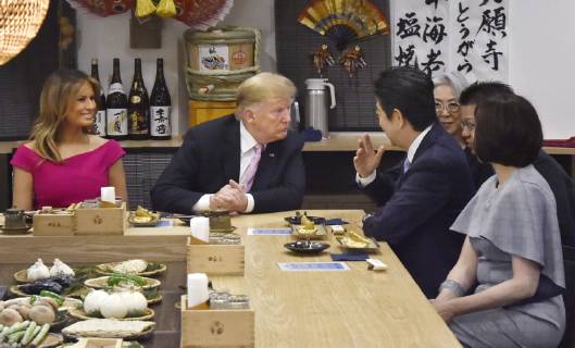 Trump in Japan Japanese Prime Minister Shinzo Abe (3rd from L) and U.S. President Donald Trump (2nd from L) dine at a Japanese charcoal grill restaurant in Tokyo on May 26, 2019. Accompanied by their respective wives -- Akie (R) and Melania (L) -- the Japanese and U.S. leaders had dinner at Inakaya in the glitzy Roppongi district on the eve of their summit talks.