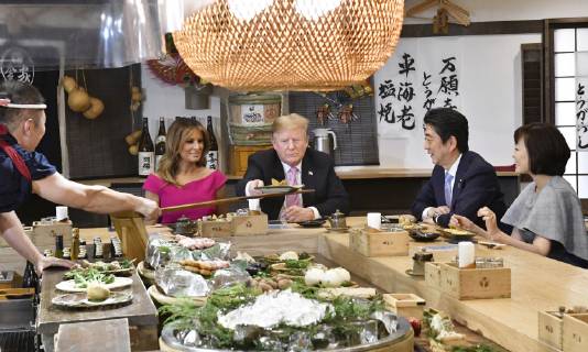 Trump in Japan Japanese Prime Minister Shinzo Abe (2nd from R) and U.S. President Donald Trump (3rd from R) dine at a Japanese charcoal grill restaurant in Tokyo on May 26, 2019. Accompanied by their respective wives -- Akie (R) and Melania (4th from R) -- the Japanese and U.S. leaders had dinner at Inakaya in the glitzy Roppongi district on the eve of their summit talks.