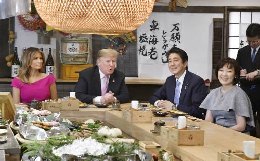 Trump in Japan Japanese Prime Minister Shinzo Abe (2nd from R) and U.S. President Donald Trump (3rd from R) dine at a Japanese charcoal grill restaurant in Tokyo on May 26, 2019. Accompanied by their respective wives -- Akie (R) and Melania (L) -- the Japanese and U.S. leaders had dinner at Inakaya in the glitzy Roppongi district on the eve of their summit talks.