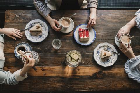Top view of friends sitting at wooden table in a cafe model released Symbolfoto  AHSF00140