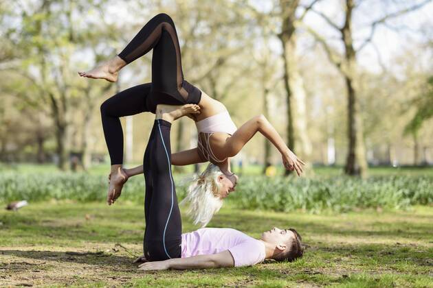 Young couple doing yoga acrobatics in an urban park model released Symbolfoto  JSMF01080