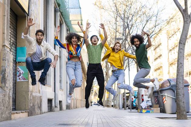 Happy group of friends having fun in the city jumping mid-air model released Symbolfoto  AFVF03547