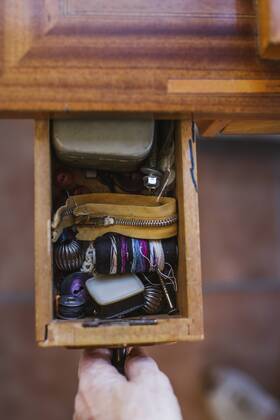 Close-up of woman opening a drawer with sewing items model released Symbolfoto property released  LJF00112