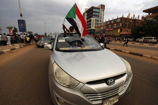 (190817) -- KHARTOUM, Aug. 17, 2019 -- A Sudanese waves a national flag to celebrate the official signing of the political and constitutional declarations between the Transitional Military Council and the opposition Freedom and Change Alliance in Khartoum, Sudan, on Aug. 17, 2019, Sudan s Transitional Military Council (TMC) and the opposition Freedom and Change Alliance on Saturday officially signed the political and constitutional declarations to mark beginning of the transitional rule in Sudan. ) SUDAN-KHARTOUM-TRANSITIONAL PERIOD DOCUMENTS-SIGNING-CELEBRATION MohamedxKhidir