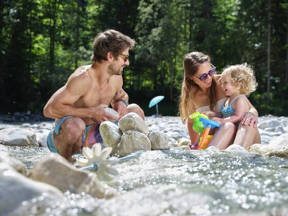 Family with daughter playing in a mountain stream model released Symbolfoto  CVF01367