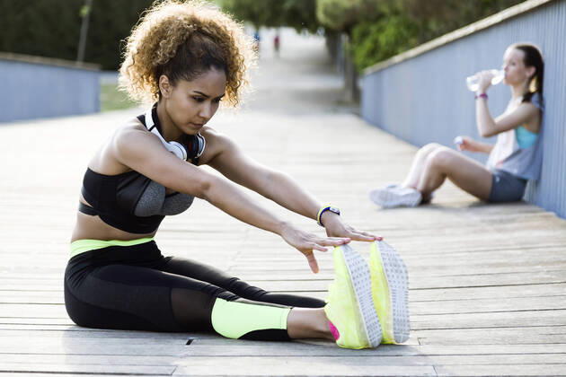 Sporty woman doing stretching exercise on a bridge model released Symbolfoto  JSRF00498