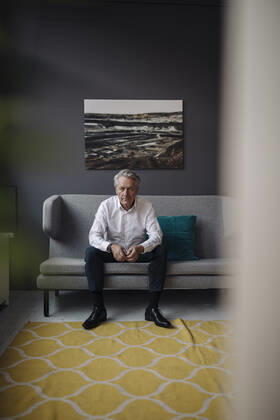 Portrait of senior businessman sitting on a couch model released Symbolfoto property released  GUSF02569