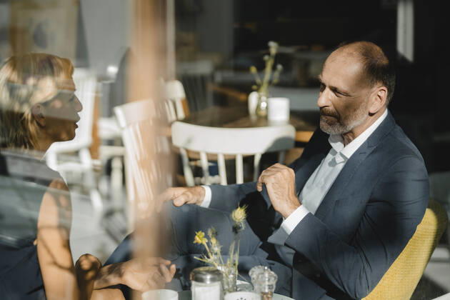 Businessman and woman having a meeting in a coffee shop model released Symbolfoto property released  KNSF06367