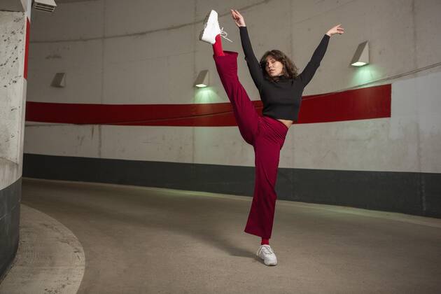 Portrait confident young woman dancing in tunnel Germany Berlin  Copyright: MarcoxBaass fStopImages1850018