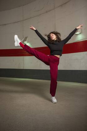 Portrait confident young woman dancing in tunnel Germany Berlin  Copyright: MarcoxBaass fStopImages1850024