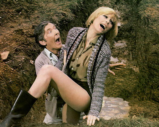 Kenneth Williams & Elke Sommer Characters: Professor Roland Crump & Professor Anna Vooshka Film: Carry On Behind (1976) Director: Gerald Thomas 03 May 1976  Copyright: ThexRankxOrganisationxAFxArchivexMaryxEvans 12456410 editorial use only