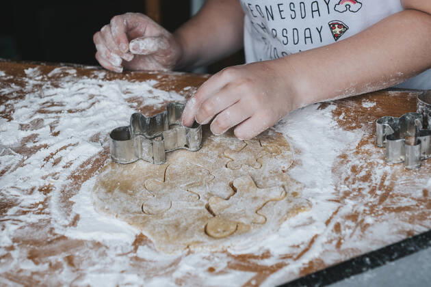 Close up of young girl cutting out gingerbread man from dough New Zealand, Taranaki, Hawera CR_LVBS191016-207949-01