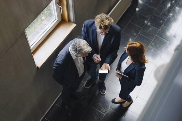 Business people with smartphone talking in modern office building model released Symbolfoto property released  JOSF04176