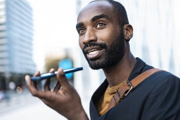 Portrait of young businessman using cell phone outdoors model released Symbolfoto  JSRF00697