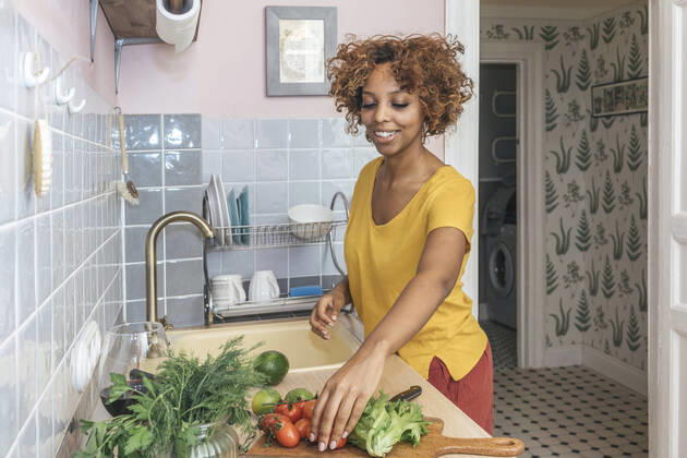 Young woman in kitchen preparing healthy meal model released Symbolfoto property released  VPIF01987