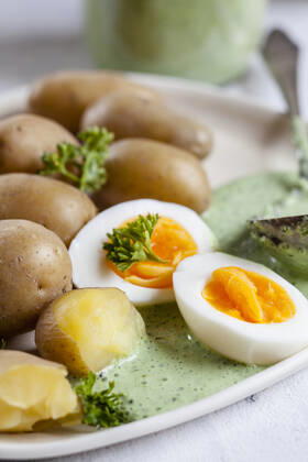 Plate of potatoes with boiled eggs, parsley and salsa verde sauce  SBDF04187
