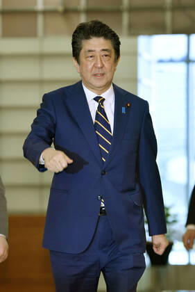 Japan PM Abe Japanese Prime Minister Shinzo Abe arrives at his office in Tokyo on March 17, 2020.