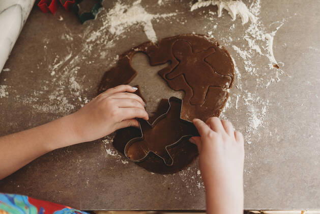 Close up of Child s Hands Making Gingerbread Men Cookies Hillsdale, MI, United States CR_OMHX200220-268395-01