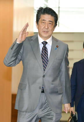 Japan PM Abe Japanese Prime Minister Shinzo Abe arrives at his office in Tokyo on March 18, 2020.