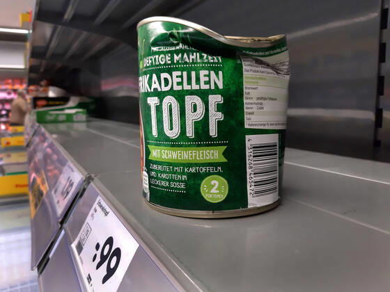 Shopping in a supermarket in Duesseldorf Dented tin can in an empty shelf Shopping