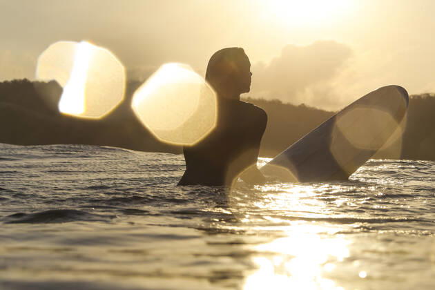 Female surfer in the ocean at sunset Lombok, Nusa Tenggara Bar., Indonesia ,model released, Symbolfoto CR_KOTRIN200312D-290307-01