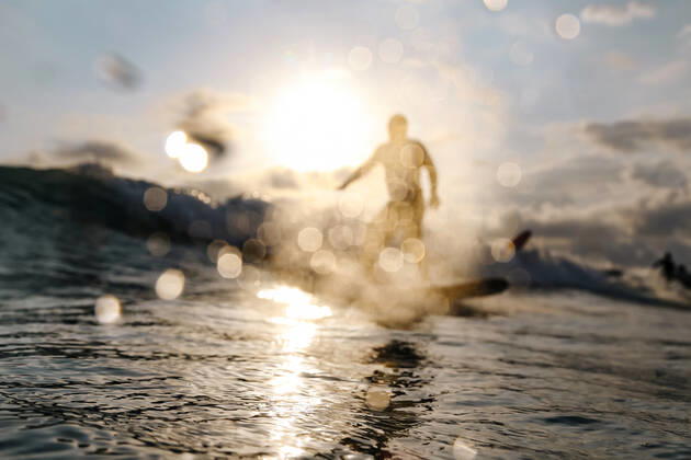 Surfer on a wave at sunset time Lombok, Nusa Tenggara Bar., Indonesia CR_KOTRIN200312O-290380-01