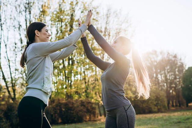 Young girls raising their hands up, jointly perform gymnastic exercises, the conception of a healthy lifestyle. ,model released, Symbolfoto CR_IVSV200318-323212-01