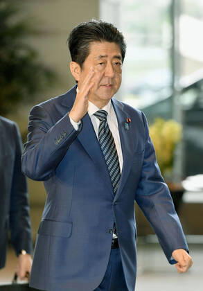 Japan PM Abe Japanese Prime Minister Shinzo Abe arrives at his office in Tokyo on March 31, 2020.