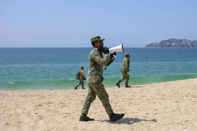 (200411) -- ACAPULCO, April 11, 2020 -- Soldiers patrol on a beach closed due to the COVID-19 pandemic in Acapulco, Mexico, April 10, 2020. (Photo by Xinhua) MEXICO-ACAPULCO-BEACH-CLOSURE FRANYELIxGARCIA 