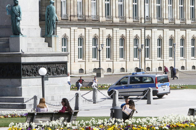 A police patrol of the Baden Württemberg State Police checks the compliance with the contact prohibitions and minimum distances at the Schlossplatz in the city centre of Stuttgart, Baden Württemberg, Bavaria, Germany