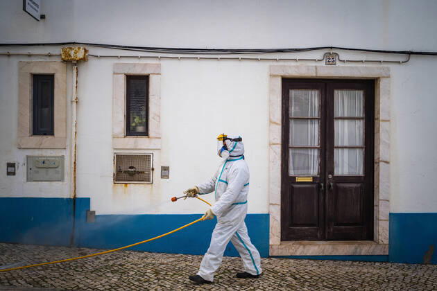 April 14, 2020, Ericeira, Portugal: An employee of the Ericeira parish council, equipped with the recommended protective materials, disinfects the street with a solution based on hypochlorite (bleach)..The municipality of Mafra had 70 cases of COVID-19 pandemic. In order to prevent the spread of the virus, the Ericeira Parish Council perform weekly street disinfection. Ericeira Portugal - ZUMAs197 20200414_zaa_s197_177 Copyright: xHenriquexCasinhasx