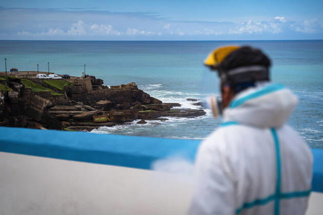 April 14, 2020, Ericeira, Portugal: An employee of the Ericeira parish council, equipped with the recommended protective materials, disinfects the street with a solution based on hypochlorite (bleach)..The municipality of Mafra had 70 cases of COVID-19 pandemic. In order to prevent the spread of the virus, the Ericeira Parish Council perform weekly street disinfection. Ericeira Portugal - ZUMAs197 20200414_zaa_s197_187 Copyright: xHenriquexCasinhasx