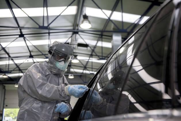 April 15, 2020, Granada, Spain: A health worker in a protective suit takes a sample for a PCR test..During the coronavirus crisis, at the ITV (technical inspection of vehicles) center in Albolote PCR tests (polymerase chain reaction) are carried out on workers of the security forces and staff of nursing homes to detect Covid 19. Granada Spain - ZUMAs197 20200415_zaa_s197_093 Copyright: xCarlosxGilx