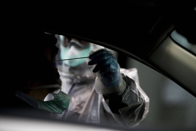 April 15, 2020, Granada, Spain: A health worker in a protective suit takes a sample for a PCR test..During the coronavirus crisis, at the ITV (technical inspection of vehicles) center in Albolote PCR tests (polymerase chain reaction) are carried out on workers of the security forces and staff of nursing homes to detect Covid 19. Granada Spain - ZUMAs197 20200415_zaa_s197_101 Copyright: xCarlosxGilx