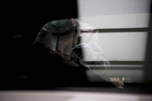 April 15, 2020, Granada, Spain: A health worker in a protective suit takes a sample for a PCR test..During the coronavirus crisis, at the ITV (technical inspection of vehicles) center in Albolote PCR tests (polymerase chain reaction) are carried out on workers of the security forces and staff of nursing homes to detect Covid 19. Granada Spain - ZUMAs197 20200415_zaa_s197_106 Copyright: xCarlosxGilx