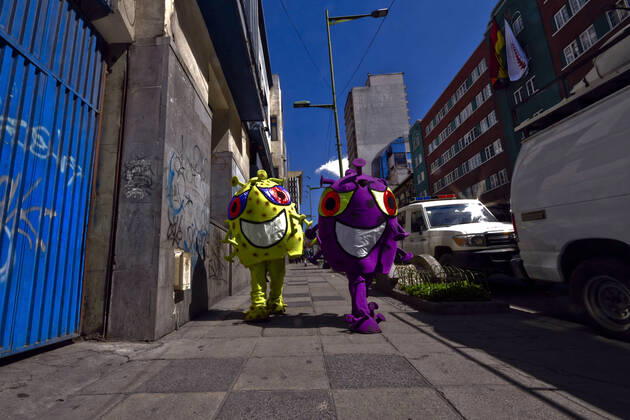 April 15, 2020, La Paz, LA PAZ, Bolivia: The Bolivian Police take to the streets of La Paz two characters representing the COVID-19 virus for a work to raise awareness among the population, among others regarding the use of masks and respect for safety distances. They sit in the rows for the benches, or in the public seats, they persecute those who do not have masks, among others La Paz Bolivia - ZUMAl72_ 20200415_znp_l72_006 Copyright: xChristianxLombardix