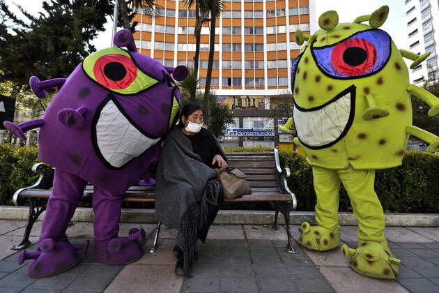 April 15, 2020, La Paz, Bolivia: Bolivian Police officers take to the streets of La Paz two characters representing the COVID-19 virus for a work to raise awareness among the population, among others regarding the use of masks and respect for safety distances. They sit in the rows for the benches, or in the public seats, they persecute those who do not have masks, among others La Paz Bolivia - ZUMAl72_ 20200415_znp_l72_004 Copyright: xChristianxLombardix