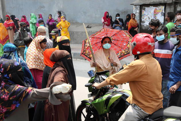 April 16, 2020: Female garment workers halt a motorcycle rider and they do not allow him to go, while they demonstrate to demand for due wages in front of their factory in South Kamlapur, Dhaka, Bangladesh; during the nationwide lockdown of the coronavirus (Covid-19) pandemic. Their garment factory had been closed for a period of time since 25, March2020 for their health issue due to the coronavirus pandemic. - ZUMAa186 20200416_zip_a186_005 Copyright: xShafayetxHossainxApollox