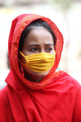 April 16, 2020: A worried female garment worker is standing on road in front of their factory, while she also demonstrates along to others to demand for due wages in South Kamlapur, Dhaka, Bangladesh; during the nationwide lockdown of the coronavirus (Covid-19) pandemic. Their garment factory had been closed for a period of time since 25, March2020 for their health issue due to the coronavirus pandemic. - ZUMAa186 20200416_zip_a186_009 Copyright: xShafayetxHossainxApollox