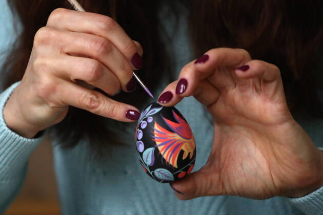 MOSCOW, RUSSIA - APRIL 16, 2020: Artist Iya Tokareva paints a wooden Easter egg Gorodets-style at her home studio; Gorodets painting, one of the traditional Russians handicrafts, originated in the middle of XIX century in the town of Gorodets, the Nizhny Novgorod Region. Anton Novoderezhkin TASS  TS0D5FE4