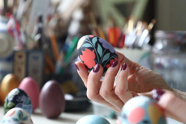 MOSCOW, RUSSIA - APRIL 16, 2020: Wooden Easter eggs painted Gorodets-style by Iya Tokareva at her home studio; Gorodets painting, one of the traditional Russians handicrafts, originated in the middle of XIX century in the town of Gorodets, the Nizhny Novgorod Region. Anton Novoderezhkin TASS  TS0D5FE9