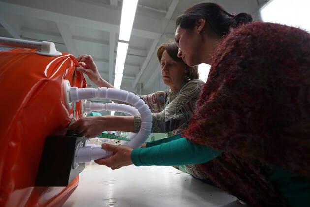 TATARSTAN, RUSSIA - APRIL 17, 2020: Experts of the Tatneft research center developing a protective box for transporting coronavirus patients at the Aznakai Kiemnere clothing factory in the town of Aznakayevo. Tatneft also launched production of medical clothing for infectious diseases physicians working with COVID-19 patients at the factory; protective suits are handed over to Tatarstan s hospitals for free. Yegor Aleyev TASS  TS0D61FB